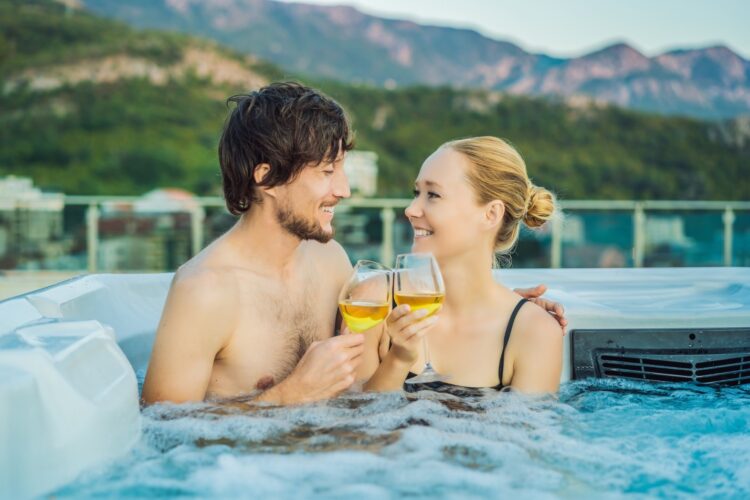 couple drink wine in pool